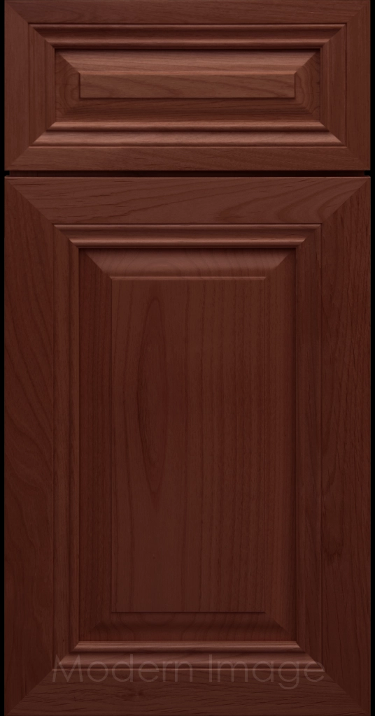 Close-up of a Cherry-stained wood cabinet door with a mitered frame and traditional Cambridge raised center panel.